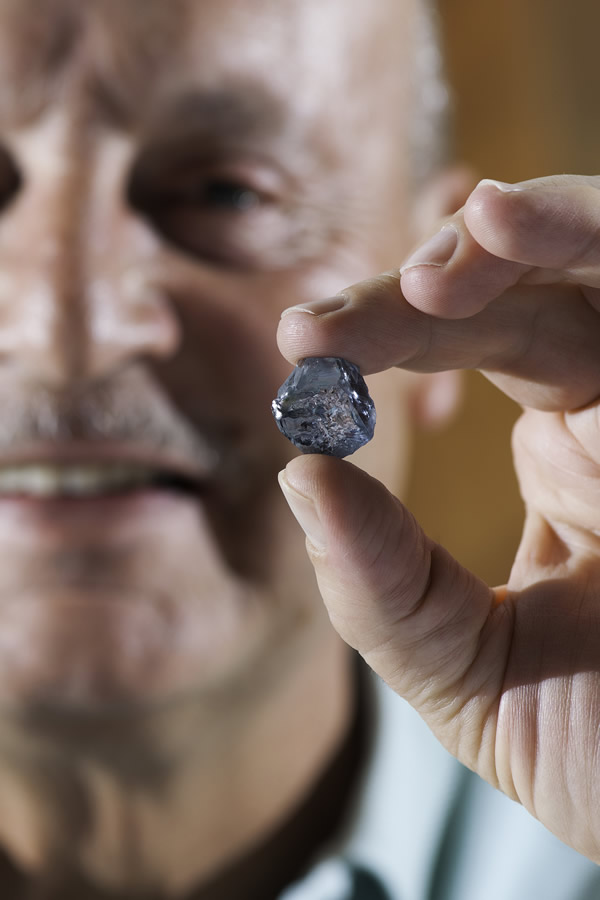 CEO Johan Dippenaar holding the exceptional 29.6 carat blue diamond recovered in January 2014